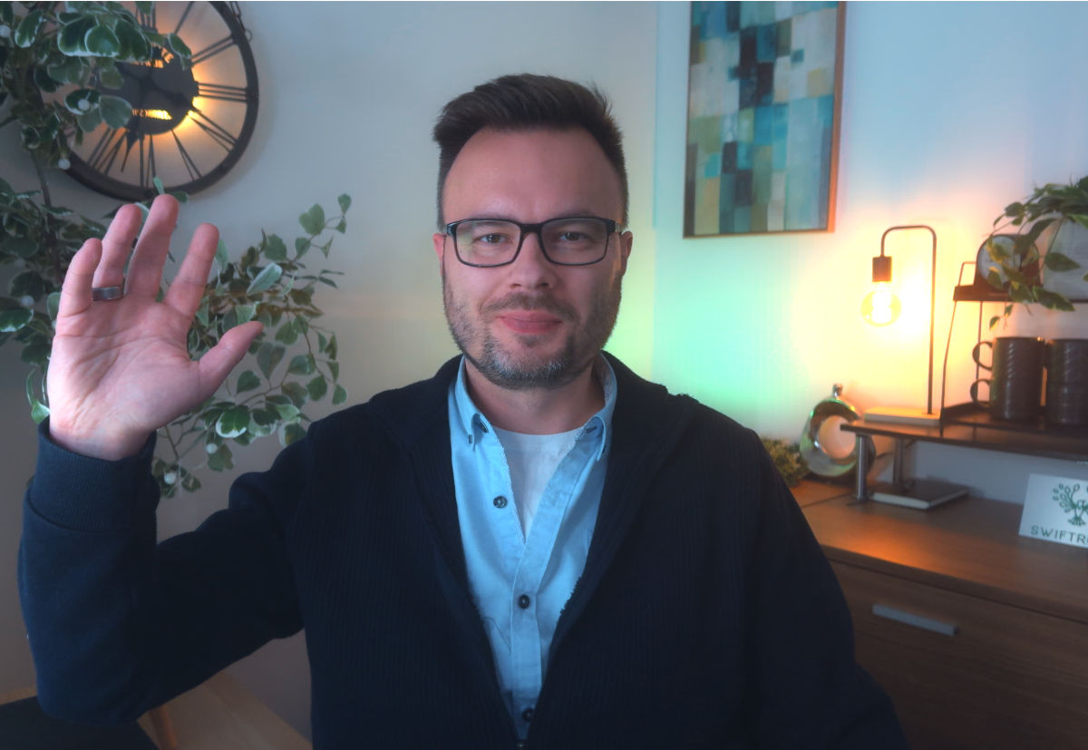 Alek Mlynek waving in his office